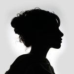 Striking black and white silhouette of a woman in profile, showcasing graceful features.
